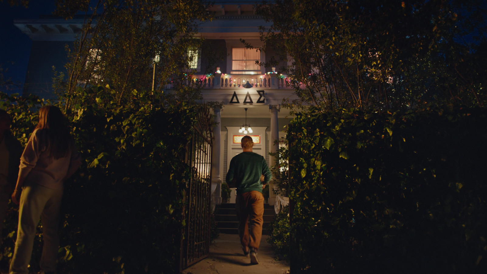 a man walking up a set of stairs at night