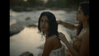 two women standing next to each other near a river