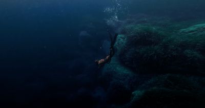 a person swimming in the ocean with a large amount of water