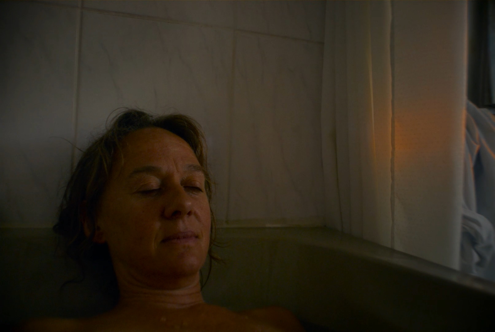 a woman that is laying down in a bath tub