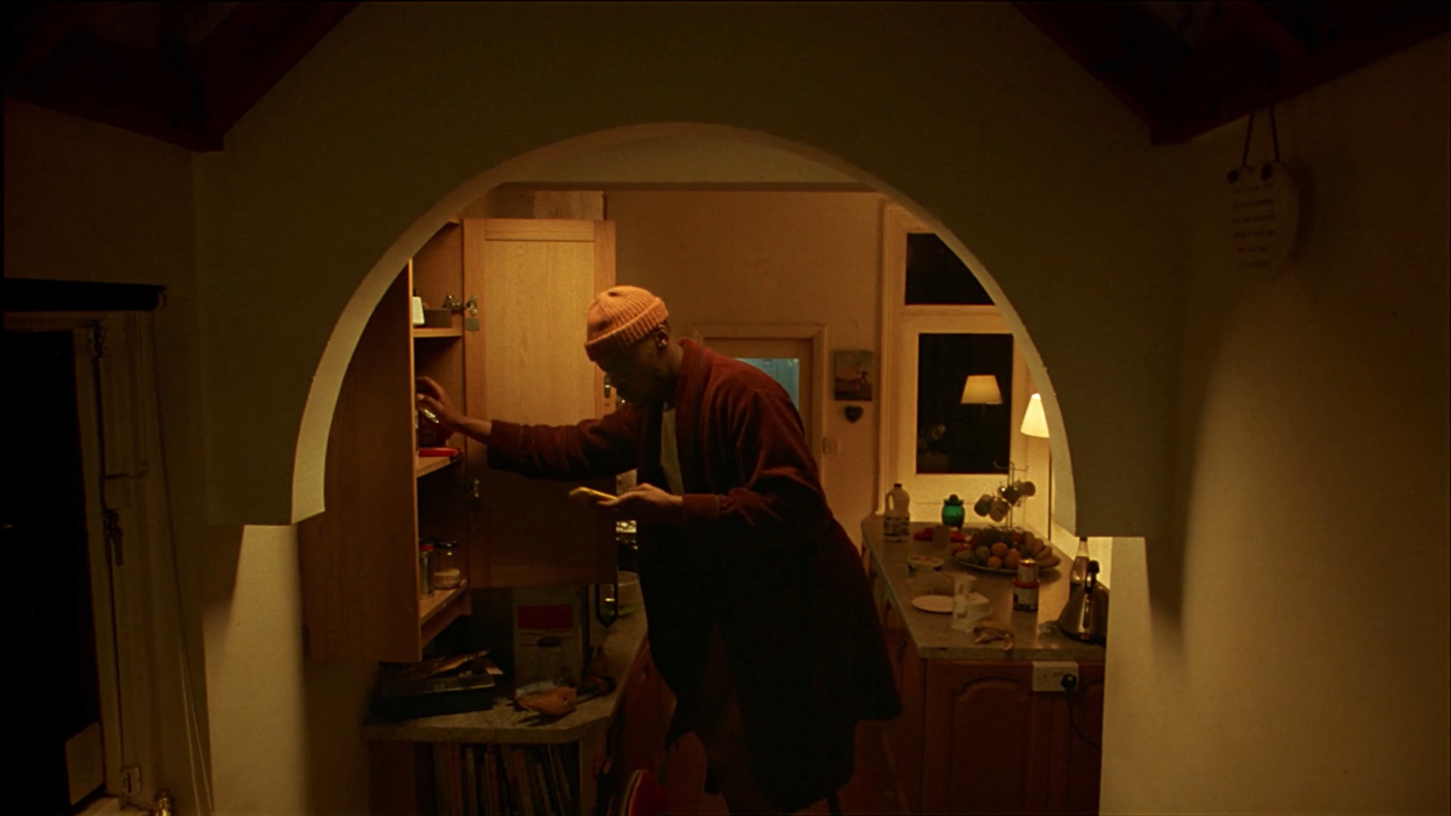 a man standing in a doorway of a kitchen