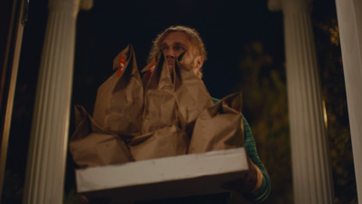 a woman holding a box with bags on it