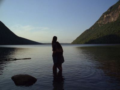 a man and a woman standing in a body of water