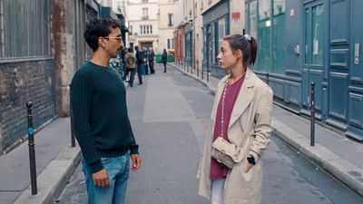 a man standing next to a woman on a street