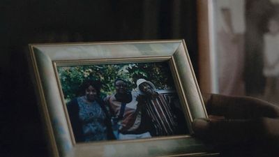 a person holding a picture of two people