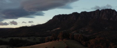 a view of a mountain with clouds in the sky