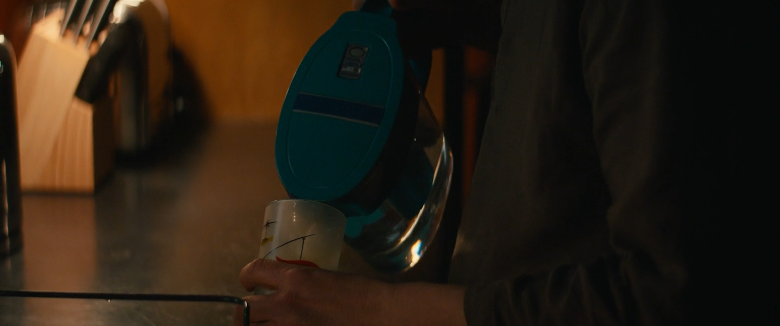 a person is using a steam iron on a kitchen counter