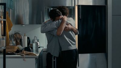 a man and a woman hugging in a kitchen