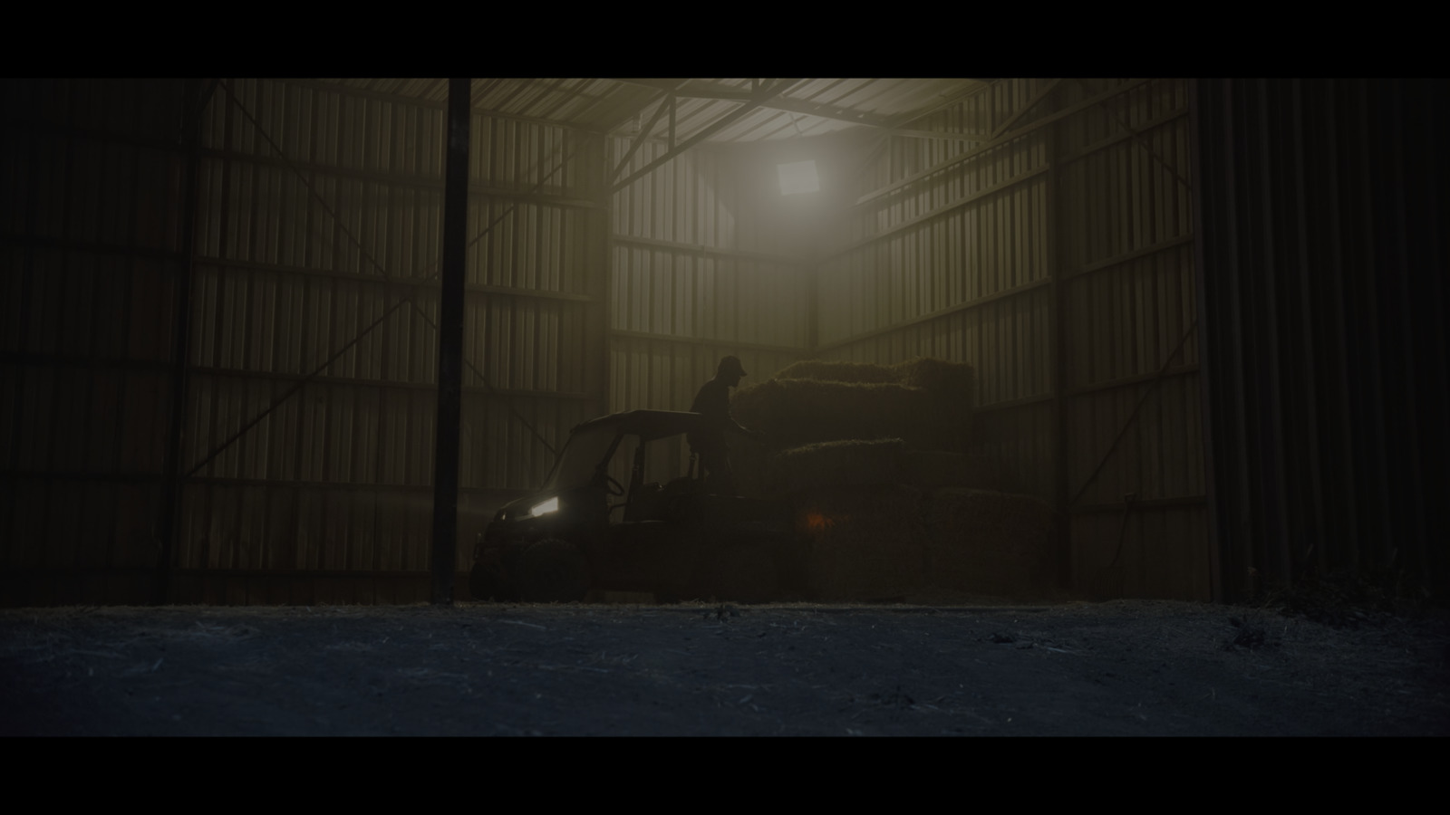 a person standing in a dark room next to a tractor