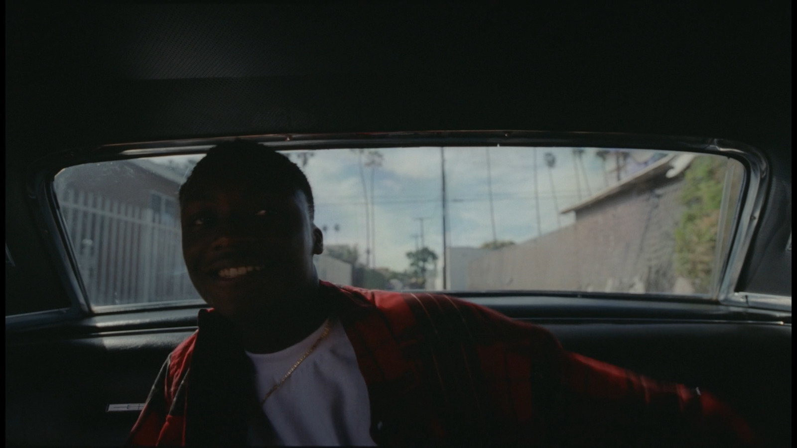 a man sitting in the back seat of a car