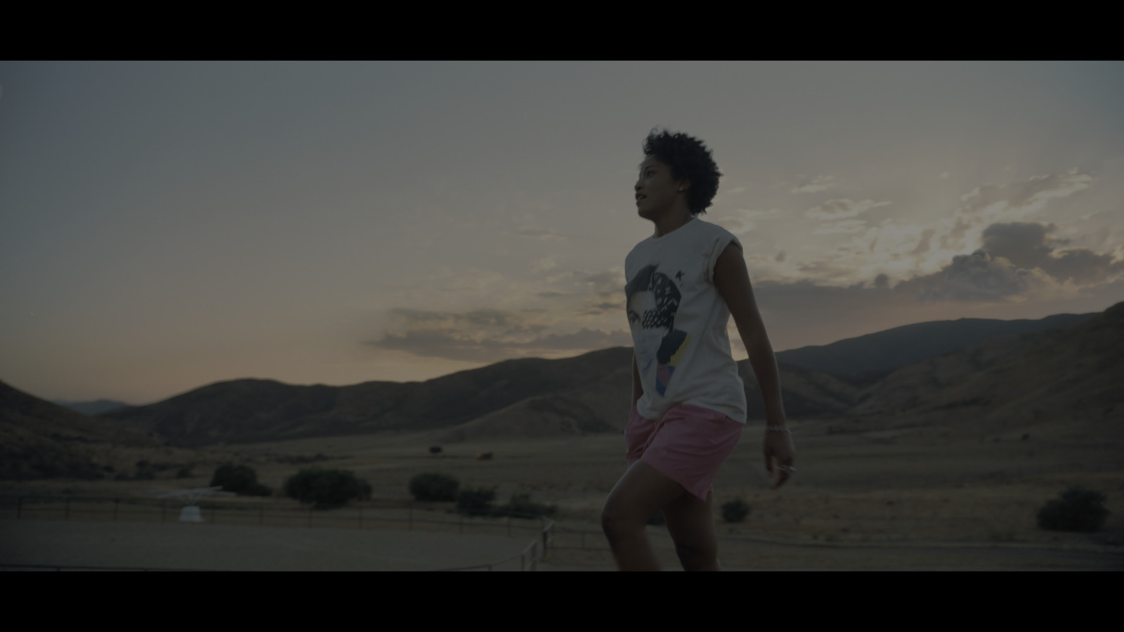 a young man is playing frisbee in the desert