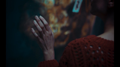 a woman in a red sweater holding her hands together