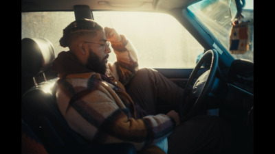 a man sitting in the driver's seat of a car