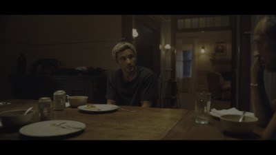 a man sitting at a table with a plate of food in front of him