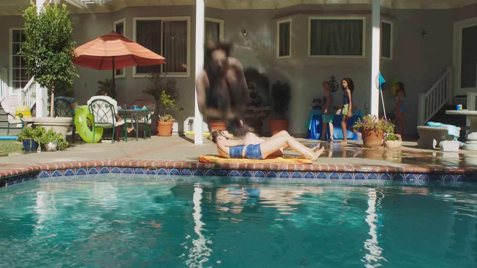 a woman laying on a towel in a pool