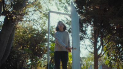 a woman standing in front of a mirror in a park