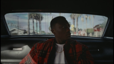 a man sitting in the back seat of a car