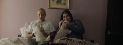 a man and a woman sitting on a bed