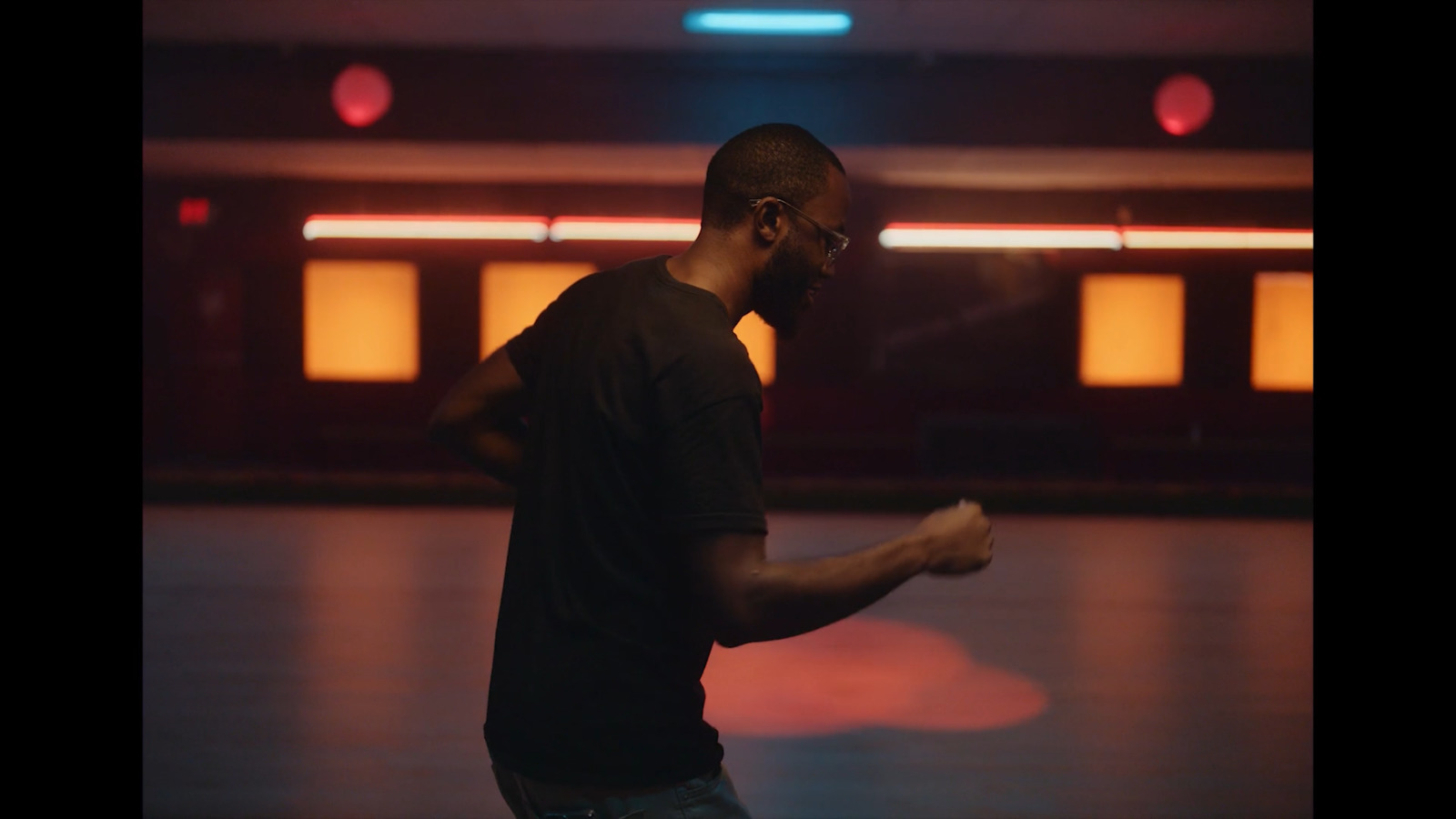 a man standing in a room holding a remote