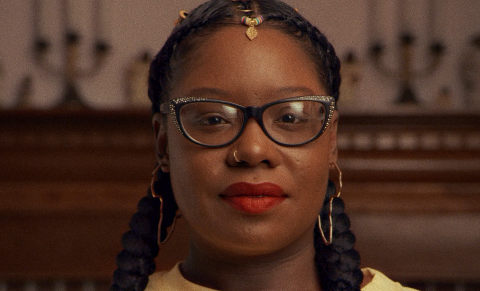 a woman wearing glasses and a yellow shirt