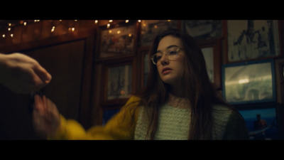 a woman wearing glasses standing in a room