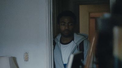 a man standing in the doorway of a house