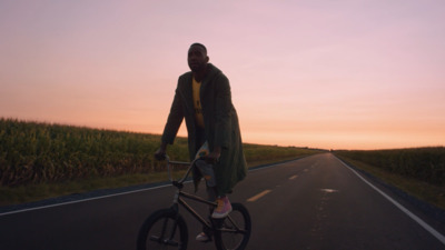 a man riding a bike down the middle of a road