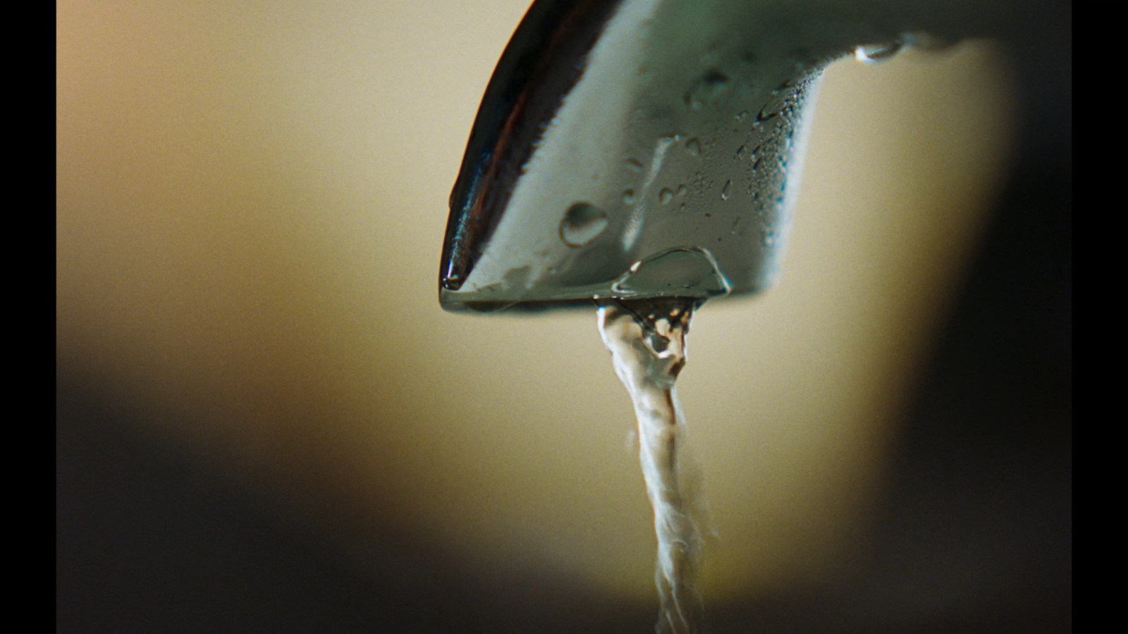 a close up of a faucet with water coming out of it