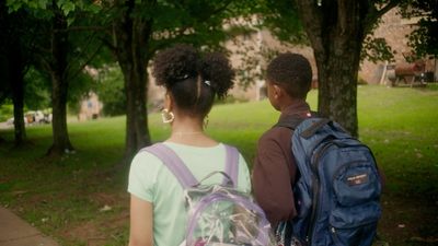 a couple of people that are standing in the grass