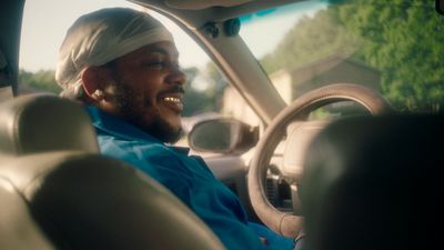 a man sitting in the driver's seat of a car