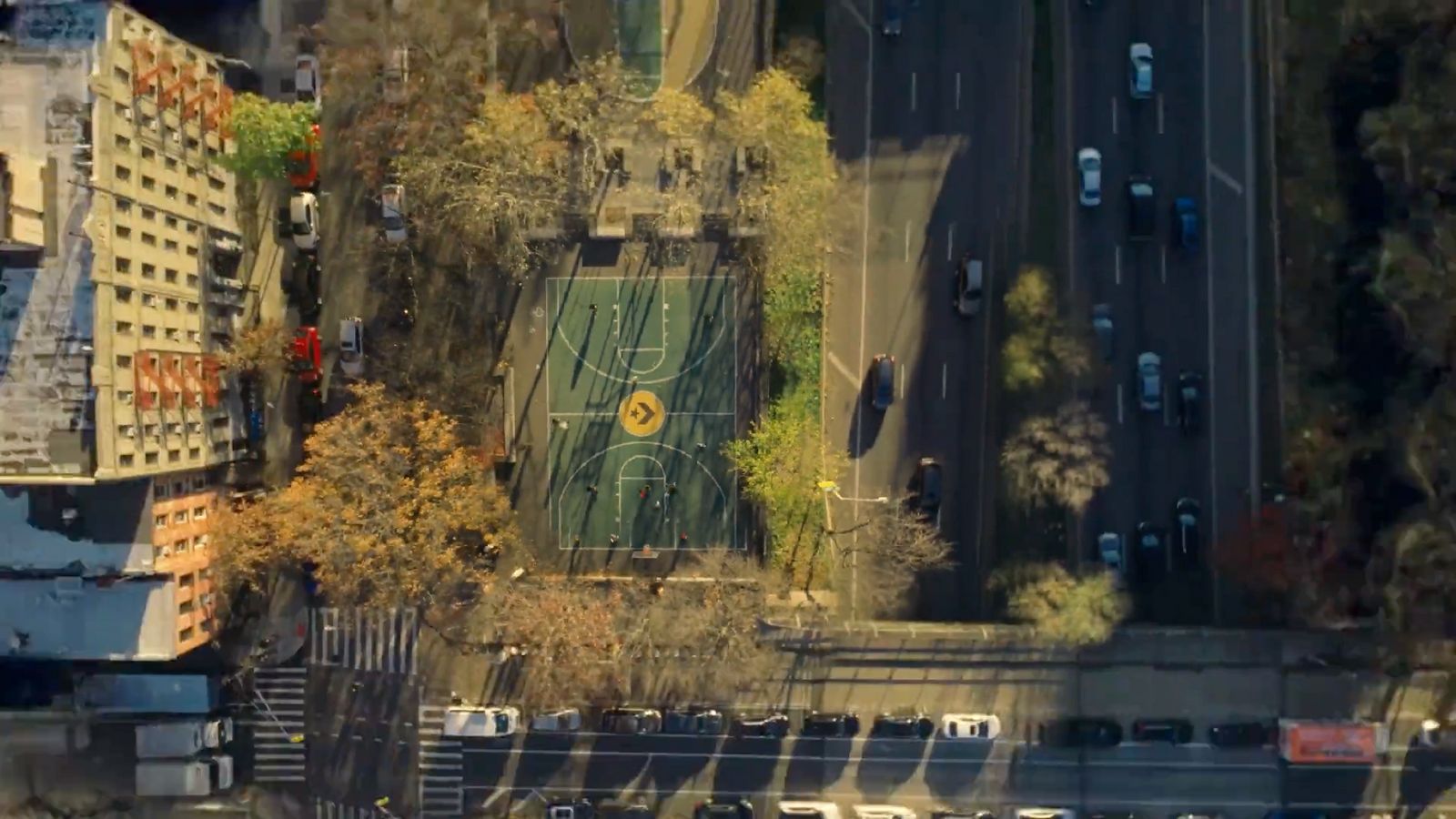 an aerial view of a basketball court in a city