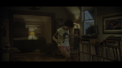 a man standing in a living room next to a window