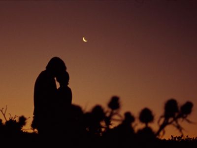 a silhouette of a person with a cell phone