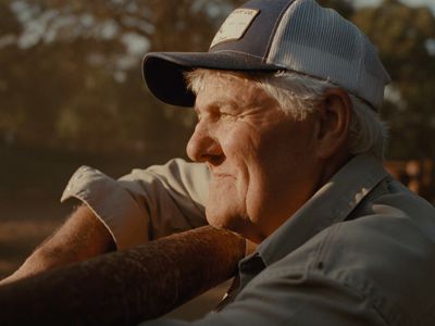 an older man wearing a hat and looking off into the distance