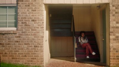 a person sitting on a set of stairs