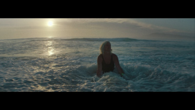 a woman sitting on a surfboard in the ocean