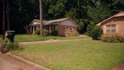 a house in the middle of a grassy yard