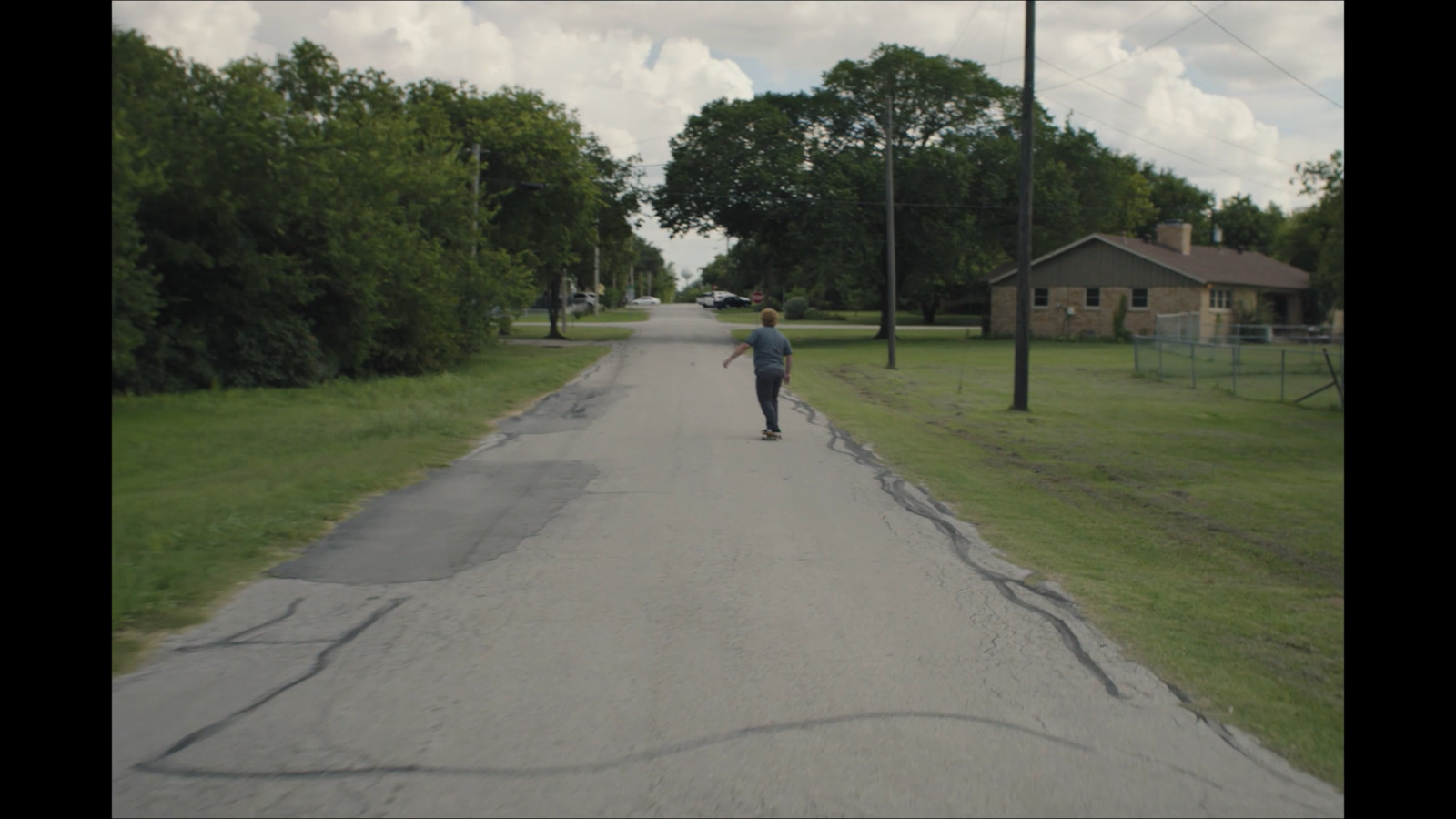 a person riding a skateboard down a street