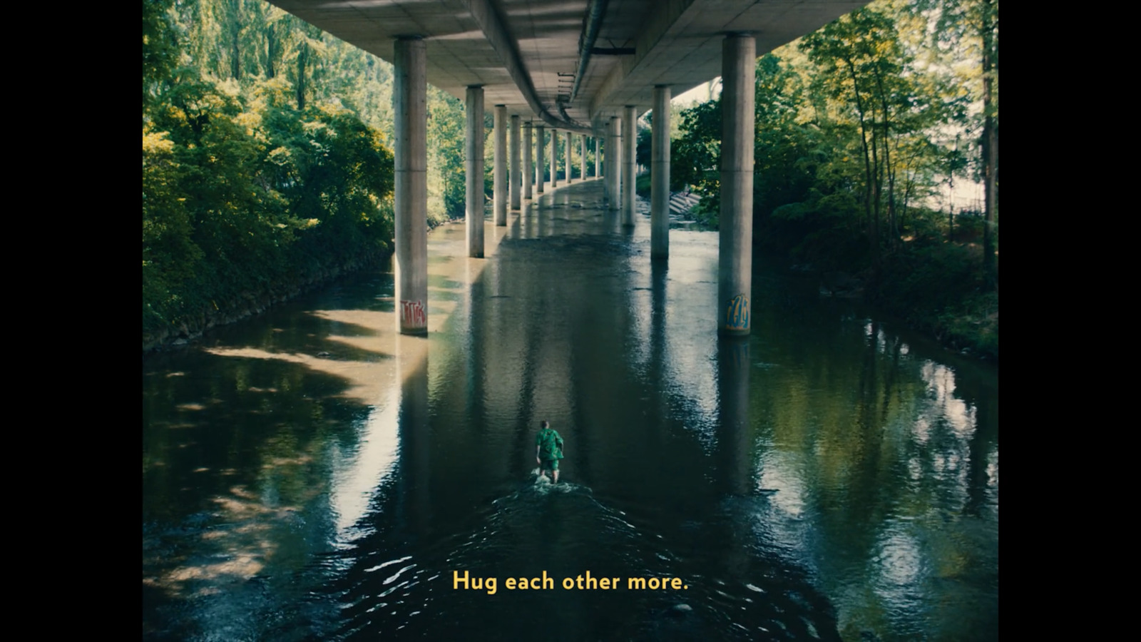 a bridge over a river with a person in a boat under it