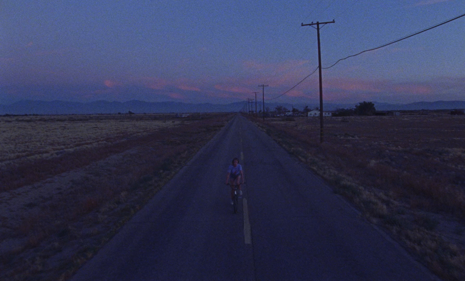 a person riding a bike down a road