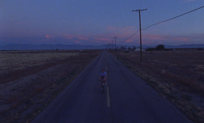 a person riding a bike down a road