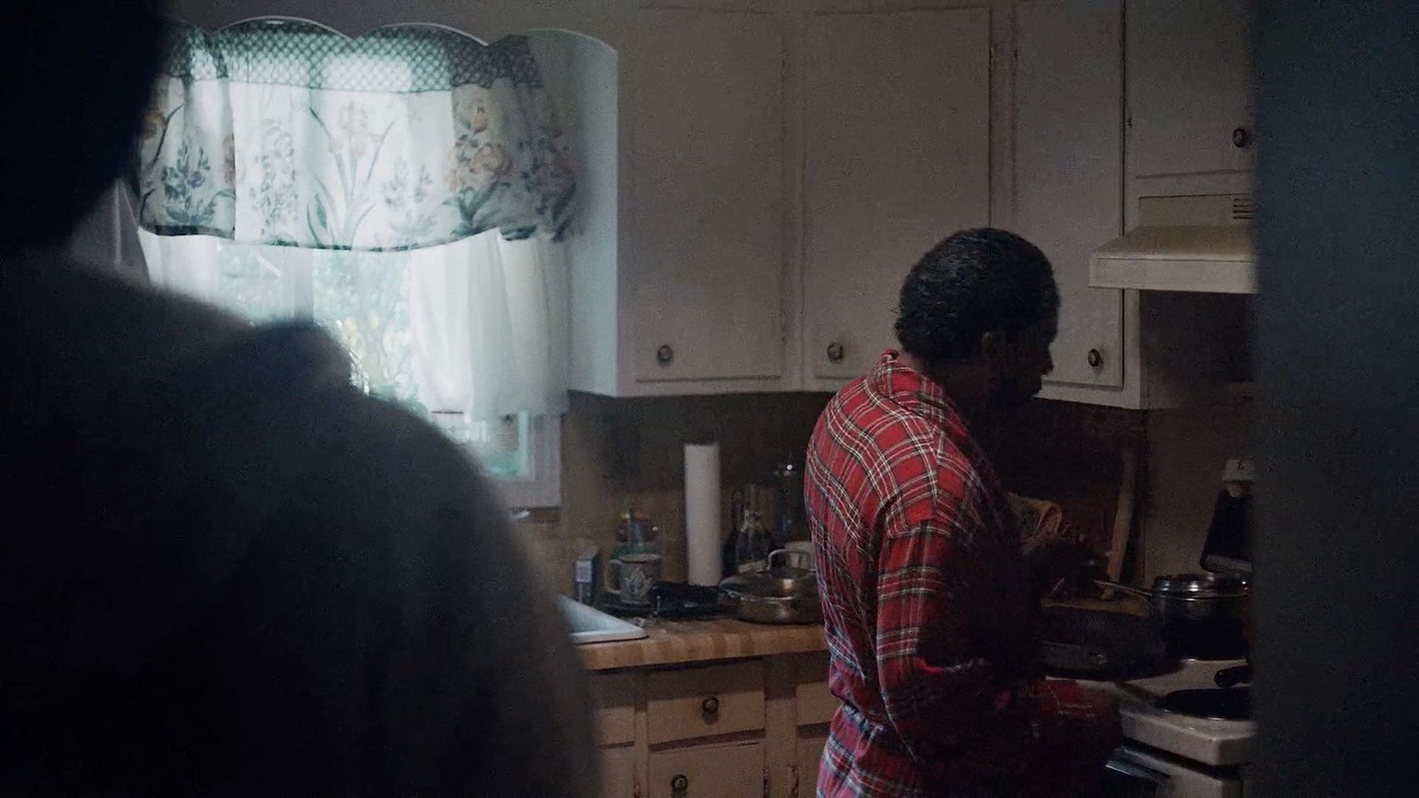 a man standing in a kitchen preparing food