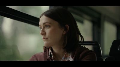 a woman looking out the window of a train