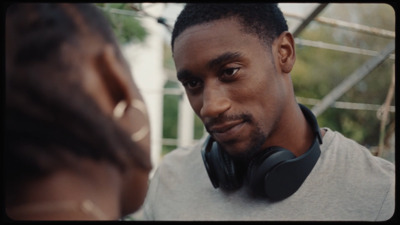 a man wearing headphones is looking at a woman