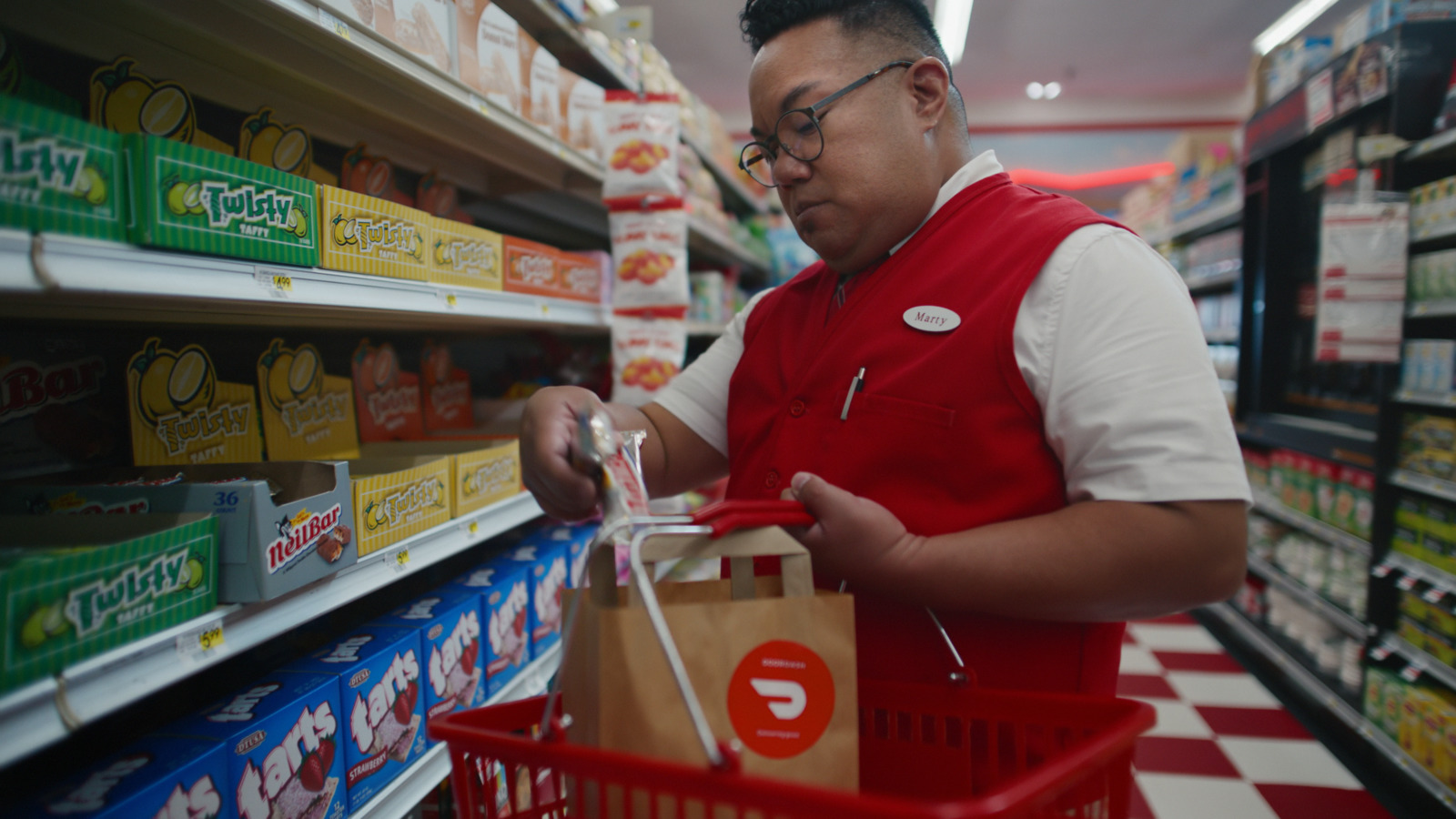 a man in a red vest is shopping in a grocery store