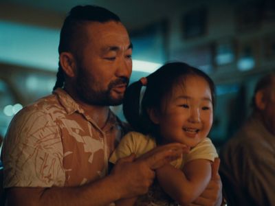 a man holding a little girl in his arms