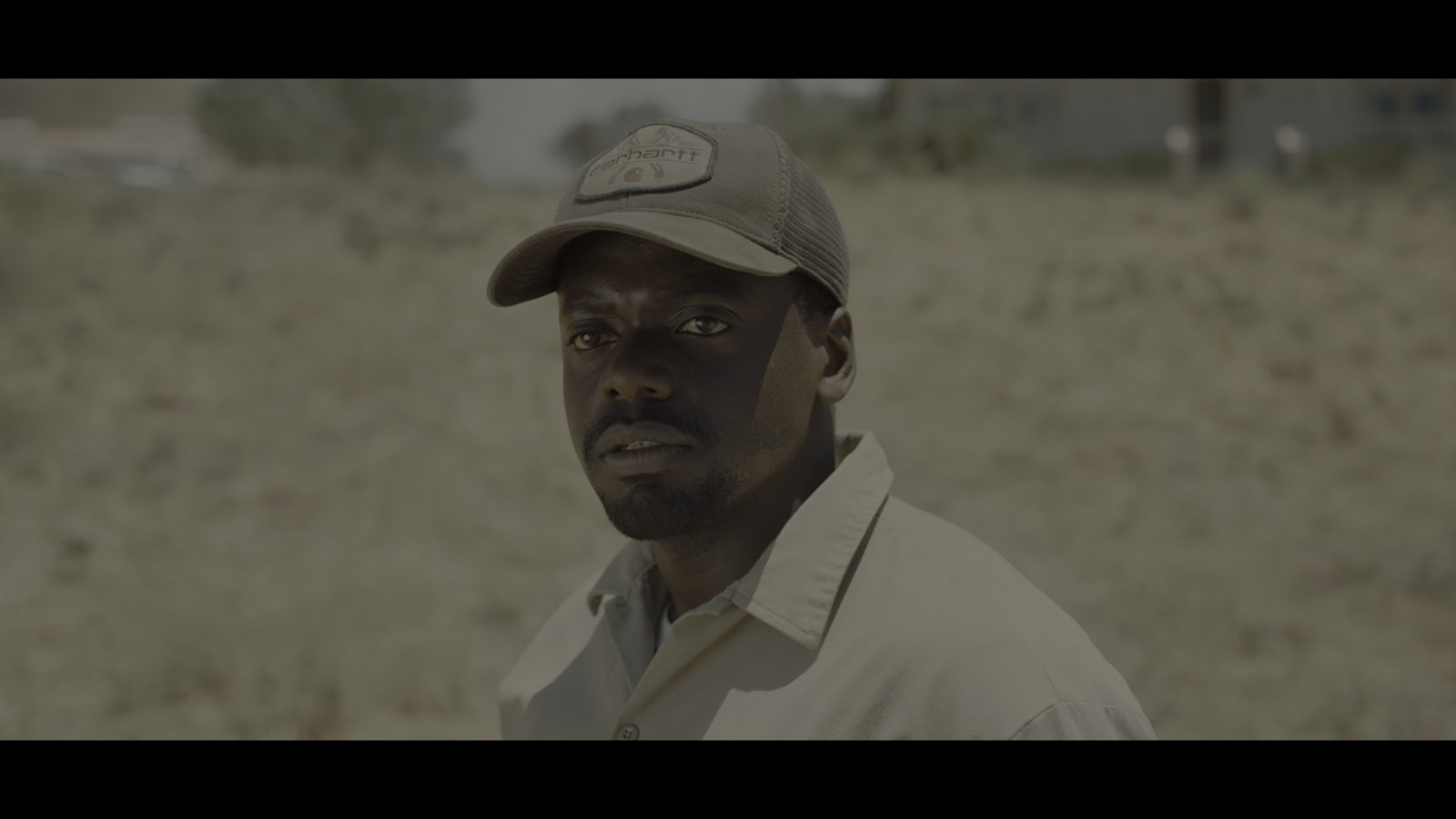 a man wearing a hat in a field