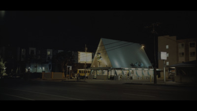 a building with a large triangular roof at night