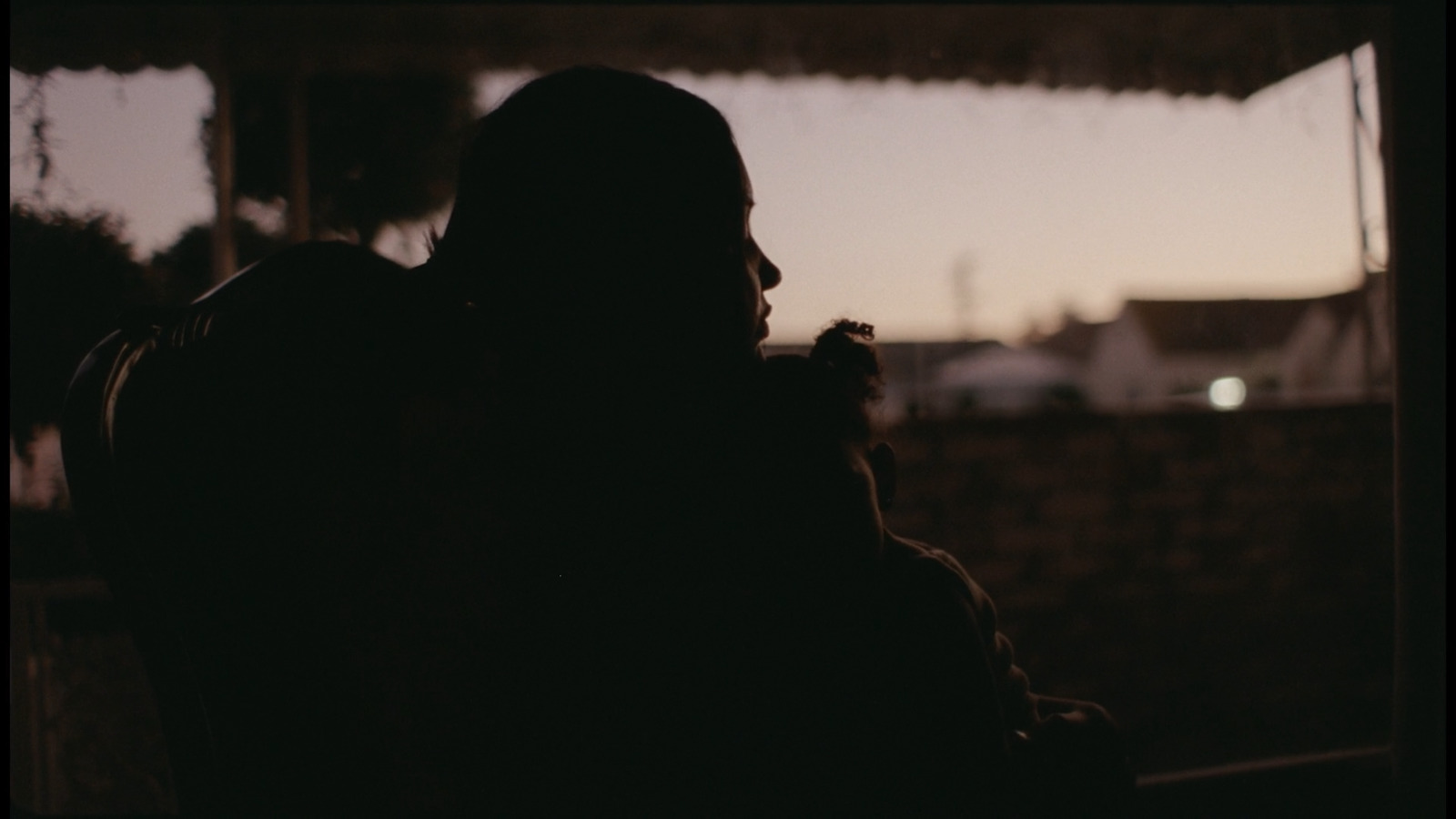 a silhouette of a person sitting in a chair