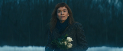 a woman holding a bouquet of flowers in her hands